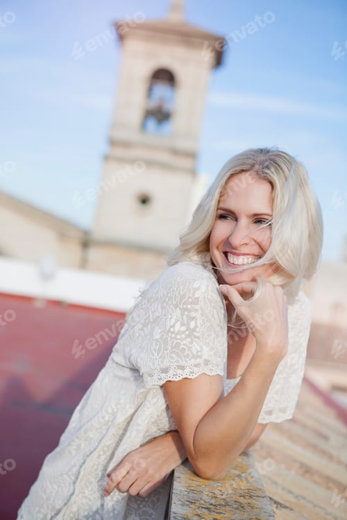 Preview: Woman on rooftop, bell tower in background