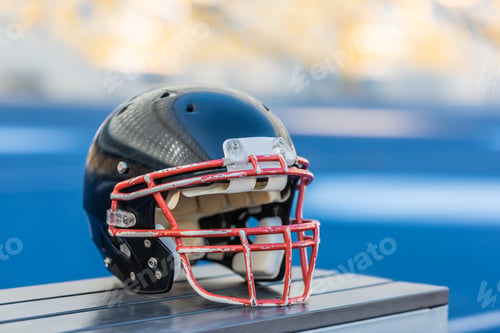 Preview: close-up shot of american football helmet lying on bench