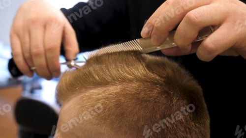 Preview: Close up of men's hair cutting scissors in a beauty salon. Master cuts hair and beard of men in the