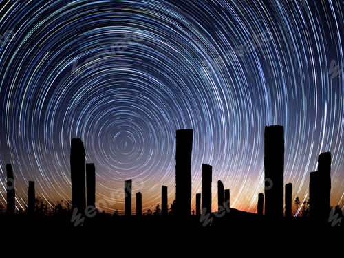 Preview: Silhouettes of wooden pillars with circle star trail in blue and orange sky, long exposure
