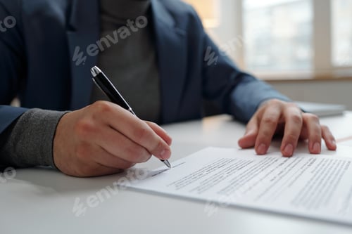 Preview: Man Signing Contract in Office with Male Hand Holding Pen