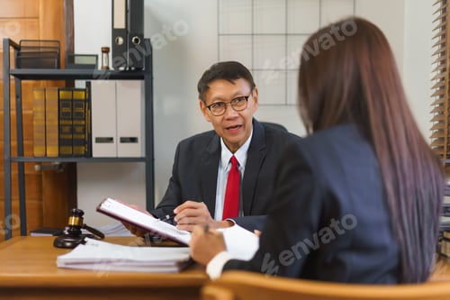 Preview: Legal and justice concept, Senior lawyer pointing on contract and discussing with female lawyer