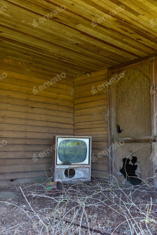 Preview: Old TV set on front porch of an abandoned homestead.