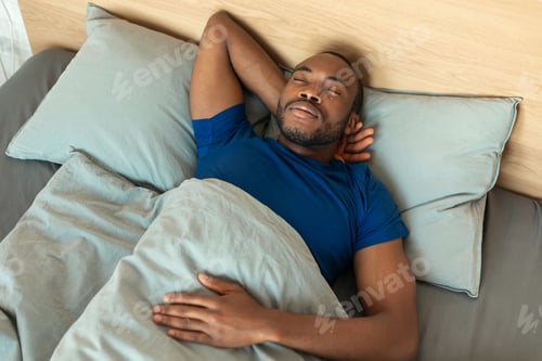 Preview: High Angle Shot Of Sleeping Black Man Napping In Bedroom