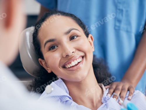 Preview: Her smile lights up a room. Shot of a young woman visiting her dentist for a checkup.