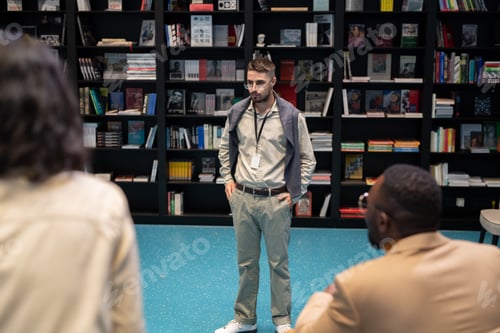 Preview: Strict young teacher or coach standing in front of intercultural students