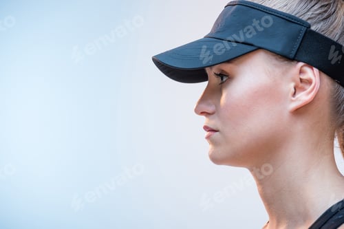 Preview: side view of beautiful thoughtful woman in black cap isolated on white