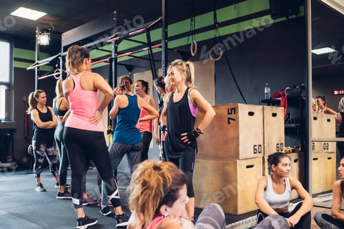 Preview: Group of women training in gym, taking a break chatting