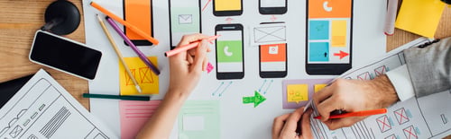 Preview: Top view of designers creative app interface for user experience design near layouts and smartphone