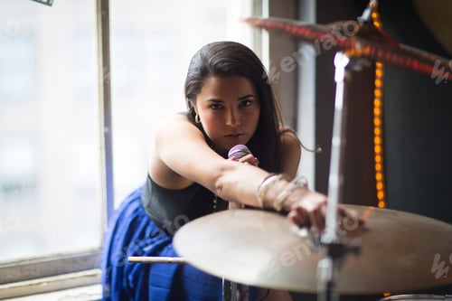 Preview: Focused drummer in action at a cozy gig