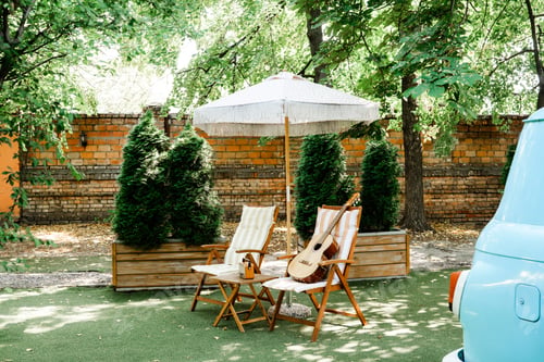 Preview: Guitar on striped chair in sunny garden for music and leisure