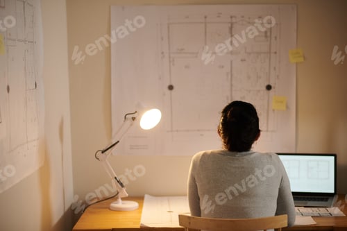 Preview: Architect Looking at Building Blueprint