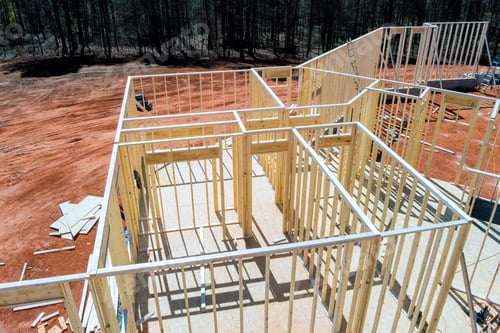 Preview: Construction site with wooden framing for new house in rural area during work day