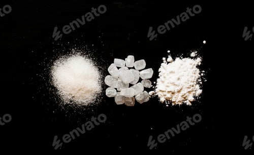 Preview: Sugar, candy sugar, white sugar powder on dark stone background, selective focus
