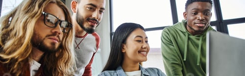 Preview: inspired multiethnic businessmen looking at laptop near overjoyed asian woman while working on