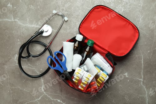 Preview: First aid medical kit on gray textured background