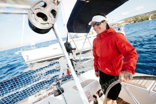 Preview: Attractive strong woman sailing with her boat