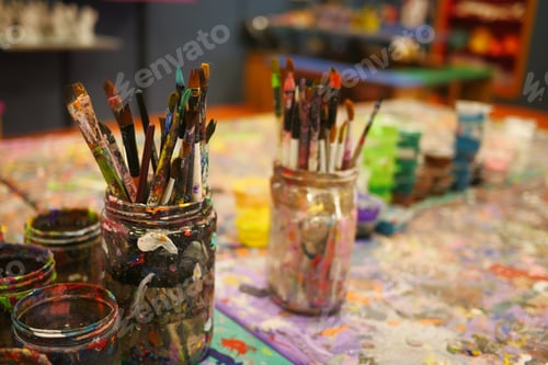 Preview: Paints and paint brushes in an artists studio.