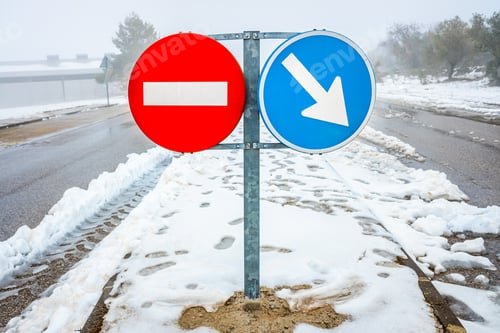 Preview: Forbidden direction road sign on a snowy road in winter.