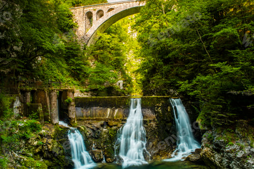 Preview: Vintgar Gorge in Slovenia. Stone Arch Rail Bridge over Waterfall