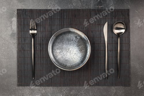 Preview: Empty plate and silverware set on wooden table