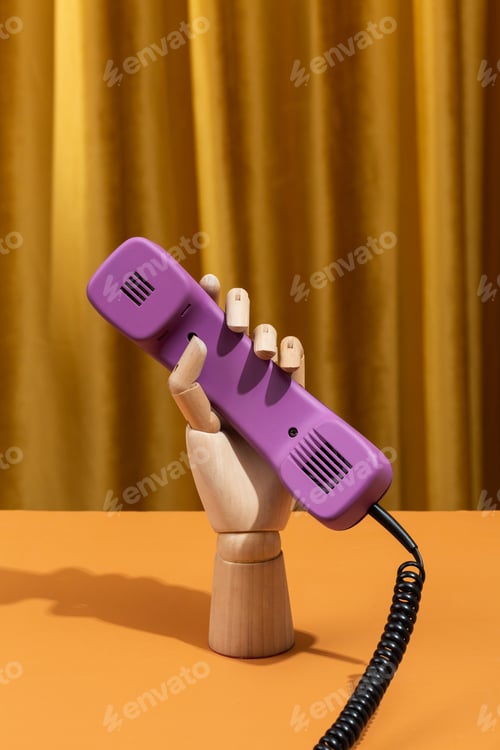 Preview: Wooden hand dials a number on a retro phone. Conceptual photo