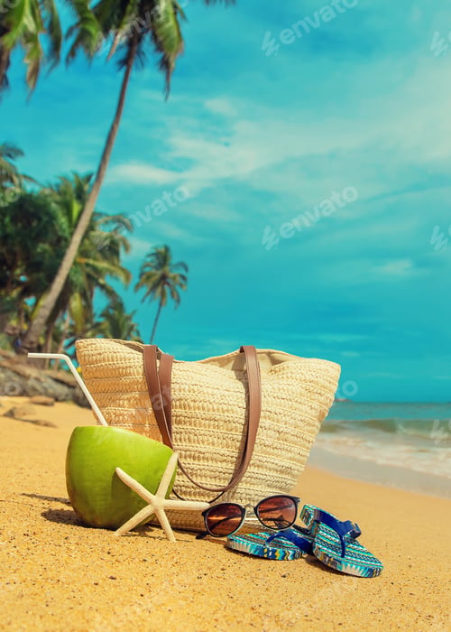 Preview: Beach bag and coconut at sea. Selective focus.