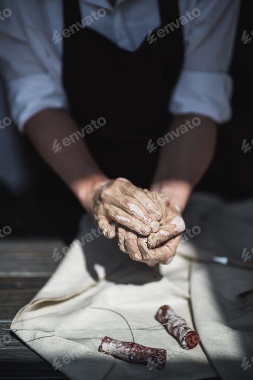 Preview: The potter's woman hands are shaping a cup from a clay. The process of creating pottery. The