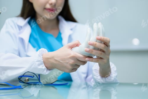 Preview: Female technician checking and controlling artificial prosthetic hand