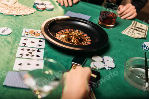 Preview: cropped image of girls playing roulette at poker table in casino