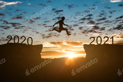 Preview: Happy new year 2021 concept. Silhouette of man jump on the cliff between 2020 to 2021 year