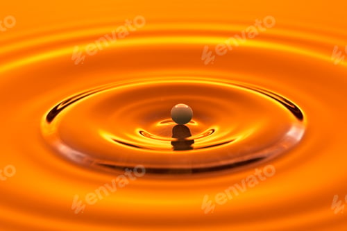 Preview: Small water drop on the surface of still water.