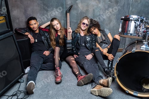 Preview: rock band sitting on floor while resting after rehearse in studio