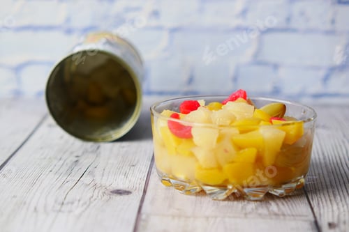 Preview: Open can of fruit cocktail on table ,