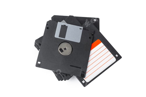 Preview: Old floppy disks stacked together on a white background with a simple layout