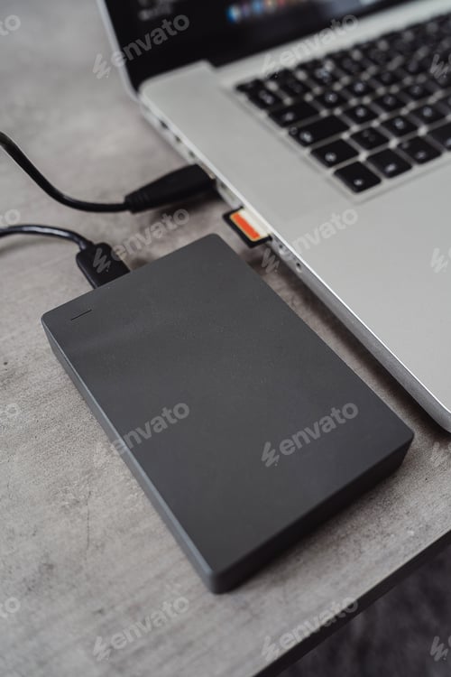 Preview: External hard disk drive connected to a modern laptop via USB