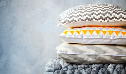 Preview: Yellow and grey pillows on the wall background