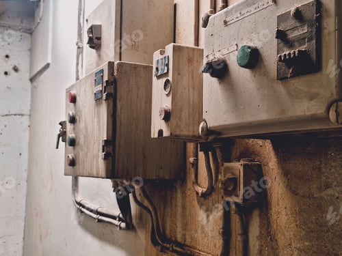 Preview: Closeup of old rusty button in a factory with grungy textured walls