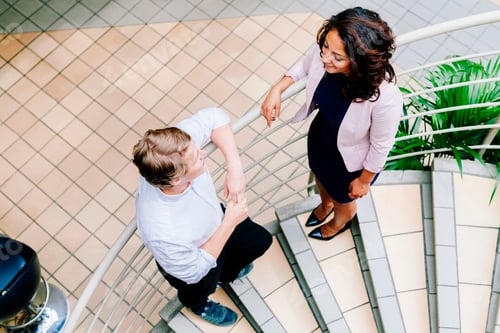 Preview: Colleagues discussing on staircase