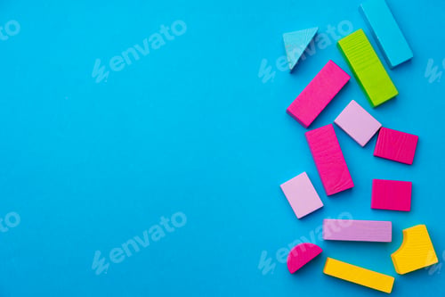 Preview: Multicolored pieces of toy constructor on blue background