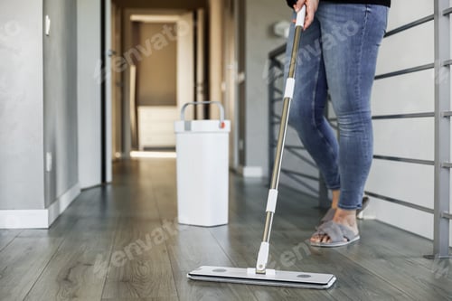 Preview: Woman mopping, wiping floor in home setting. Housewife uses mop, plastic bucket