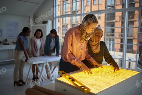 Preview: Architecture, blueprint and planning business women on light table or box for creative vision, brai