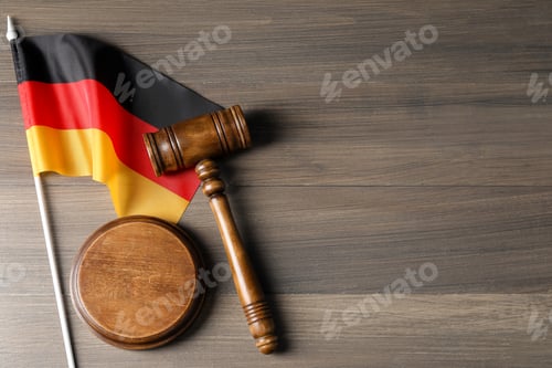 Preview: Judge's gavel and flag of Germany on wooden table, top view. Space for text