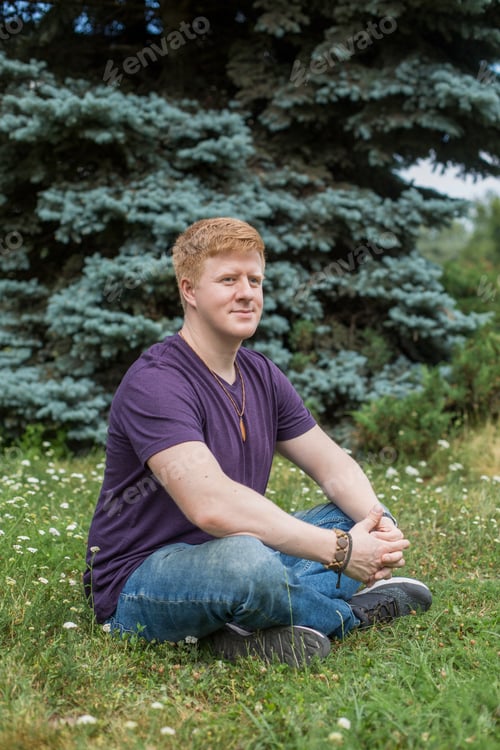 Preview: Man sits on the grass during lunch break