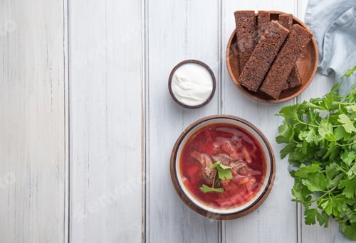 Preview: Traditional Ukrainian Russian borsch (beetroot soup) with meat in a bowl on a wooden background