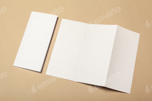 Preview: Blank folded paper and flat sheet on a beige background for crafting projects