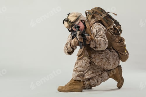Preview: Soldier in tactical gear aiming weapon during a training session in a studio setting