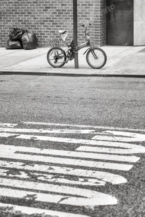 Preview: An old bicycle locked to a sign post in Chinatown, NYC, USA.