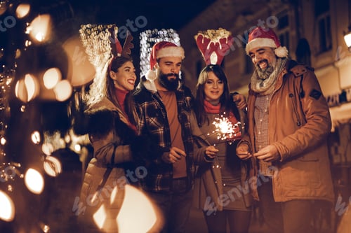 Preview: Friends With Sparklers Having Fun At A Christmas Night Out