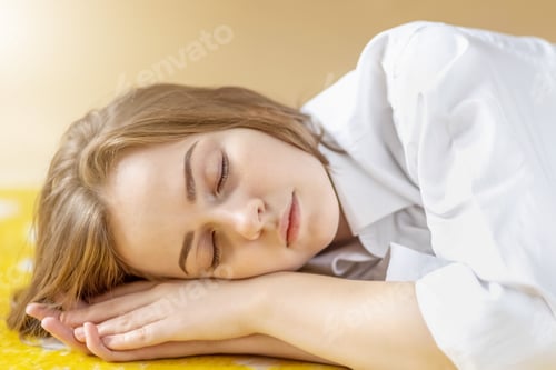 Preview: Portrait of a young teenage girl with closed eyes lying on the floor. Sleeping. Mental health.
